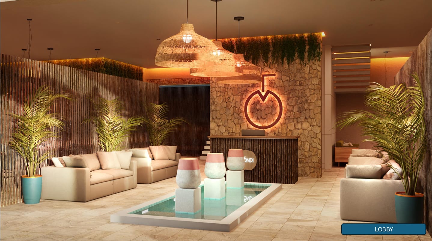 Lobby with a stone wall, a lit logo, rattan lamps and water
